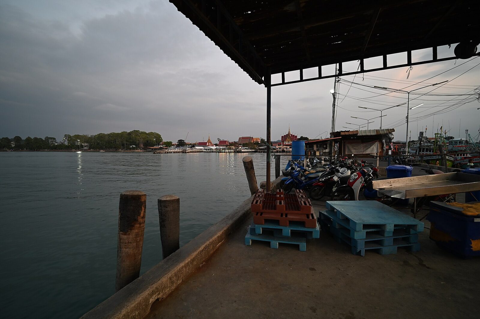 A quiet marina and working dock area at dusk