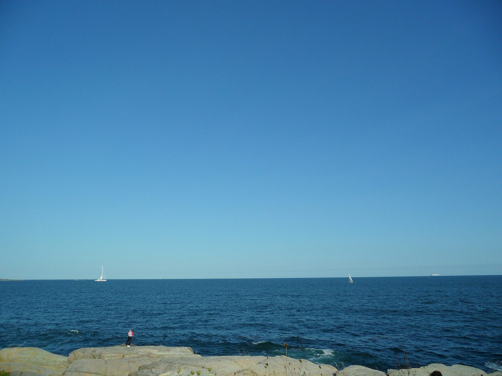 Narragansett Bay water and shoreline beneath a broad coastal sky