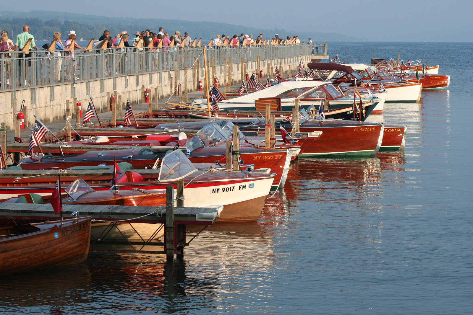 Classic wooden boats lined up at the Skaneateles Village Pier