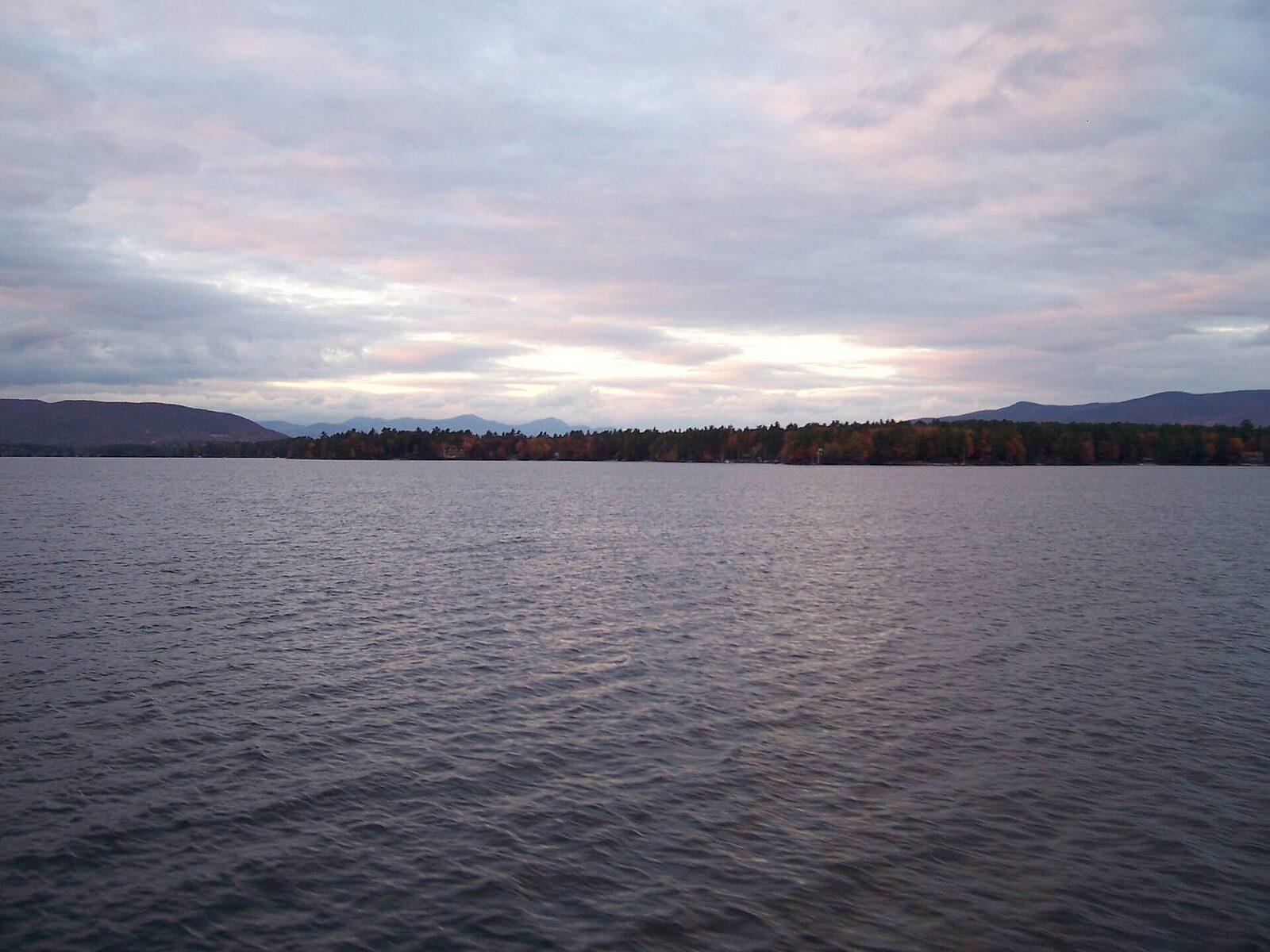 A small cruising boat underway on a Northeast lake